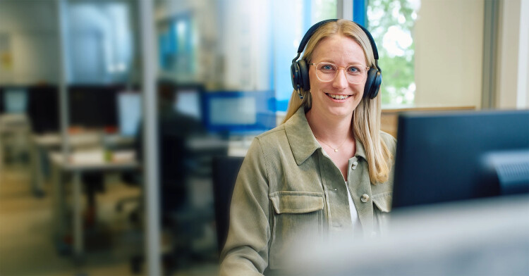 Product manager in the office with a headset.