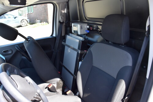 An Energy Unit behind the passenger seat of a car