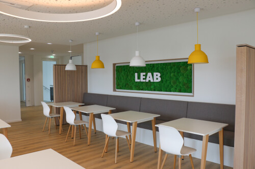 The break room in the new building in Busdorf with yellow and white hanging lights