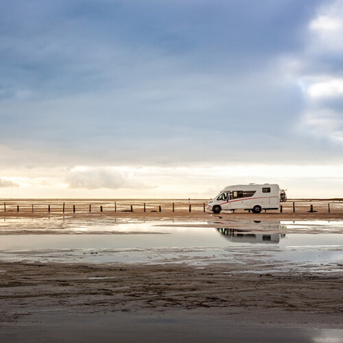 A motorhome stands by the sea